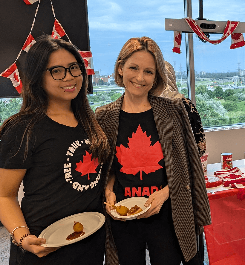 Two employees holding plates of food