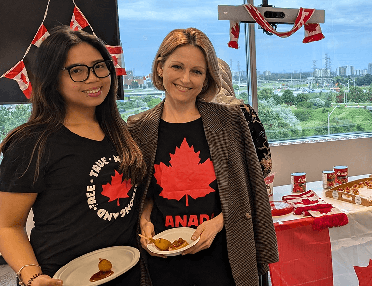 Two employees holding plates of food